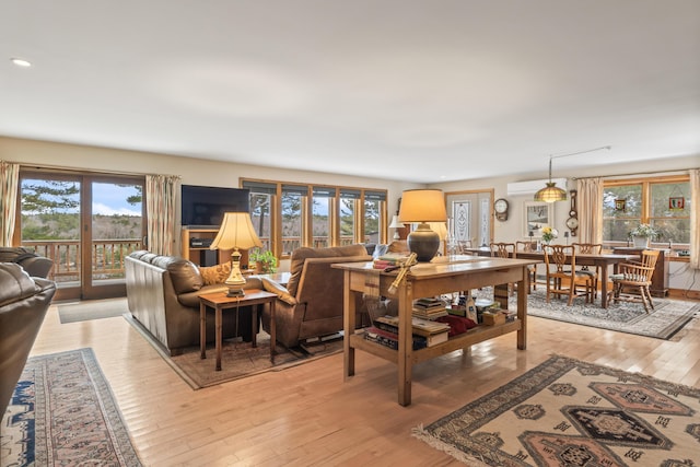 living area with recessed lighting, a healthy amount of sunlight, and light wood-style floors