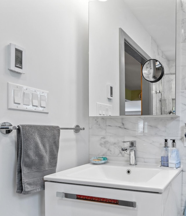 bathroom with decorative backsplash and vanity