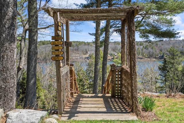 exterior space featuring a water view and a forest view