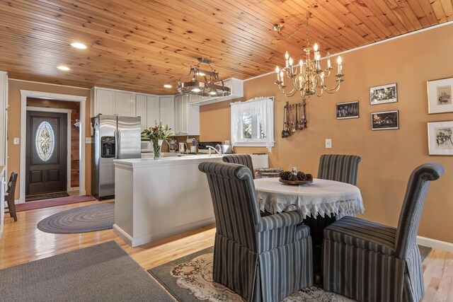 dining area featuring wood ceiling, baseboards, a notable chandelier, light wood-style floors, and recessed lighting