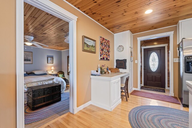 entrance foyer with wood ceiling, ceiling fan, crown molding, baseboards, and light wood-style flooring