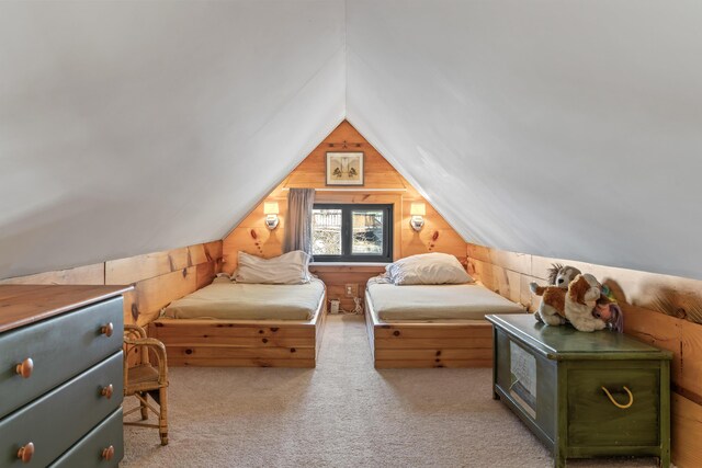 bedroom featuring carpet floors, wood walls, and vaulted ceiling