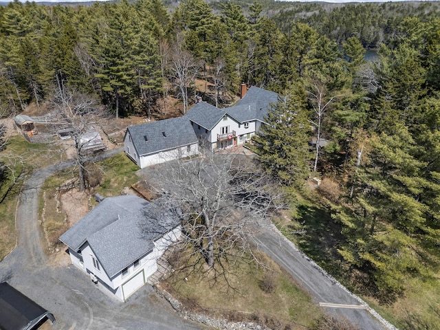 drone / aerial view featuring a wooded view