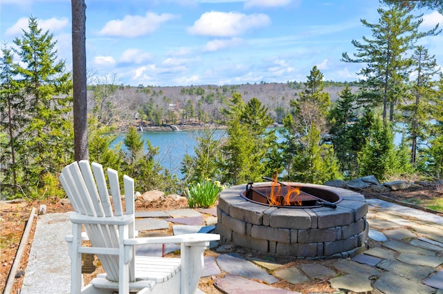view of patio / terrace with a water view and a fire pit