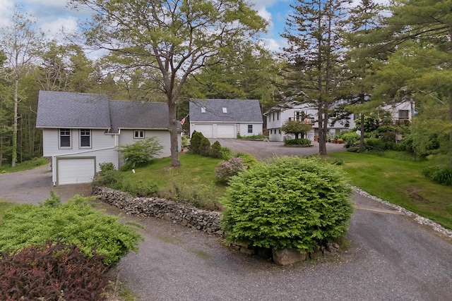 33 Taylor Rd, Westport Island, ME 04578 - view of front of house with an attached garage, asphalt driveway, and a front yard