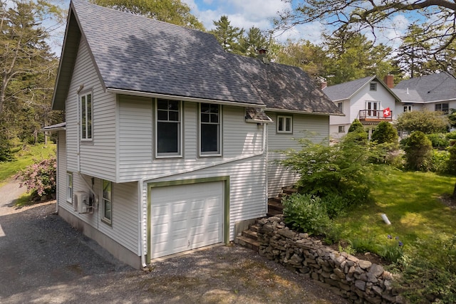 33 Taylor Rd, Westport Island, ME 04578 - view of side of property featuring a shingled roof, a garage, and a chimney