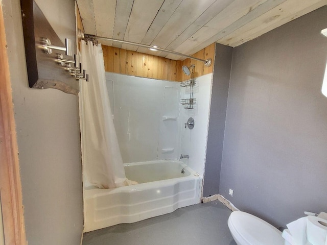 bathroom with baseboards, shower / tub combo, finished concrete flooring, and toilet
