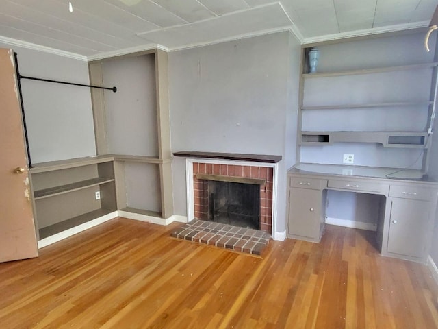 unfurnished living room featuring crown molding, baseboards, a fireplace, and wood finished floors