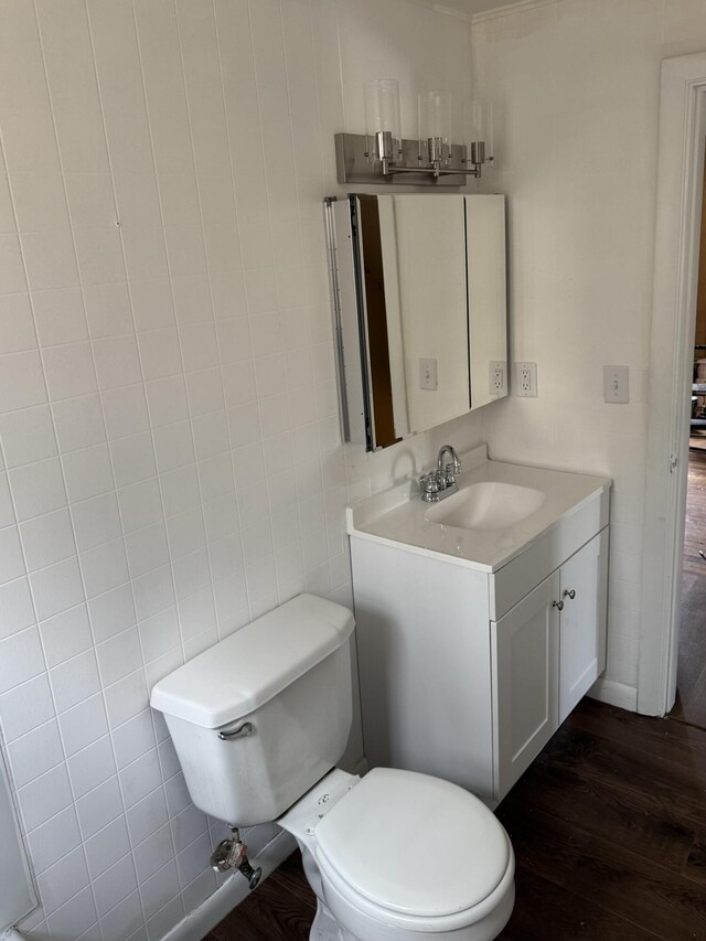 bathroom featuring vanity, toilet, and wood finished floors