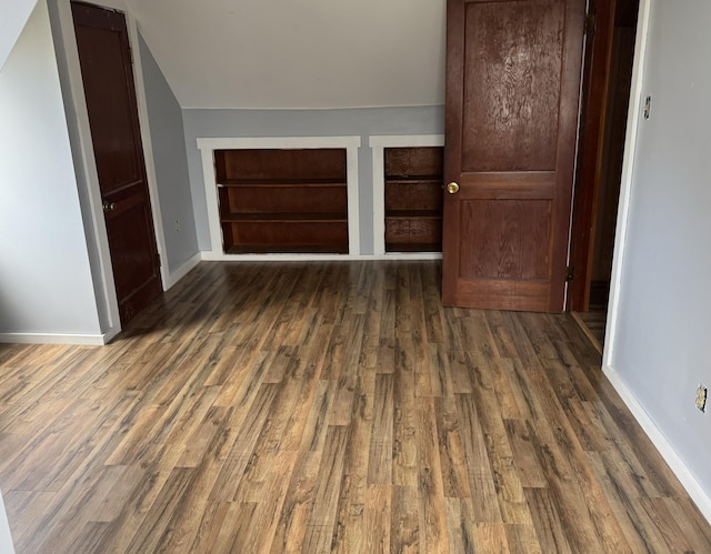unfurnished bedroom featuring baseboards and wood finished floors