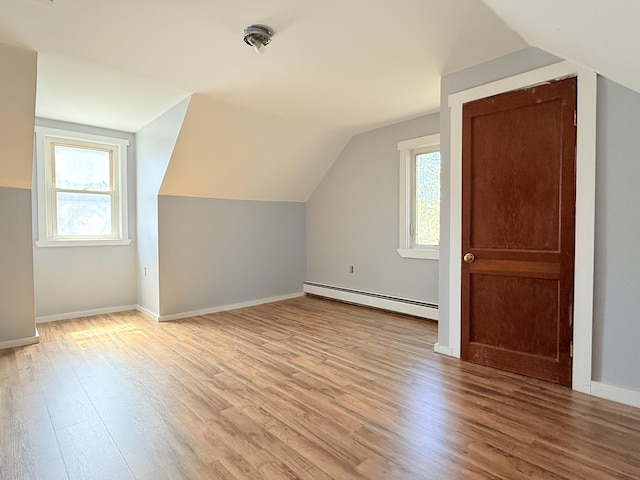 171 Granite St, Mexico, ME 04257 - additional living space with light wood-style floors, baseboards, lofted ceiling, and a baseboard radiator