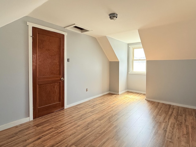 171 Granite St, Mexico, ME 04257 - additional living space featuring vaulted ceiling, wood finished floors, and visible vents
