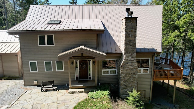 1 Mccracken Ln, Bristol, ME 04539 - view of front of home featuring a standing seam roof, a chimney, metal roof, and a wooden deck