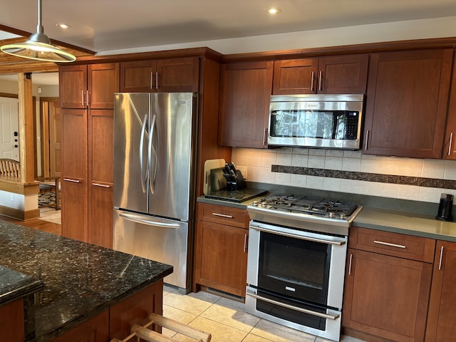 1 Mccracken Ln, Bristol, ME 04539 - kitchen with stainless steel appliances, recessed lighting, tasteful backsplash, dark stone countertops, and light tile patterned flooring