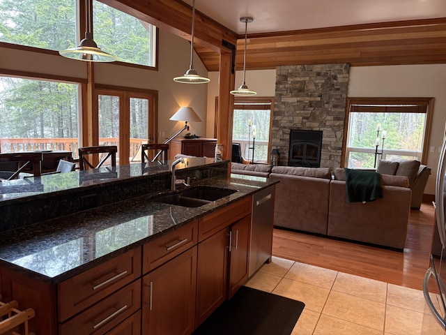 1 Mccracken Ln, Bristol, ME 04539 - kitchen with a sink, a fireplace, light tile patterned floors, hanging light fixtures, and plenty of natural light