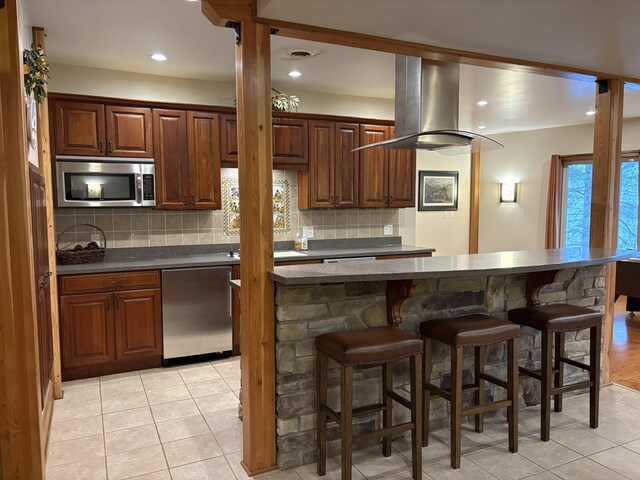 1 Mccracken Ln, Bristol, ME 04539 - kitchen featuring appliances with stainless steel finishes, a breakfast bar, dark countertops, backsplash, and recessed lighting