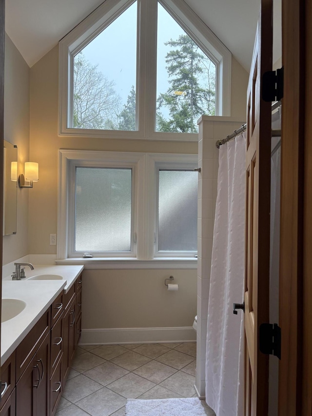 1 Mccracken Ln, Bristol, ME 04539 - bathroom featuring tile patterned flooring, healthy amount of natural light, baseboards, and double vanity