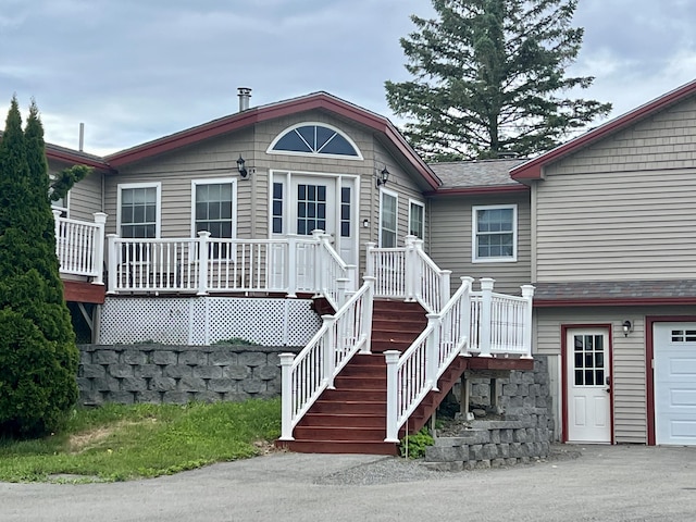 back of house featuring driveway and a garage