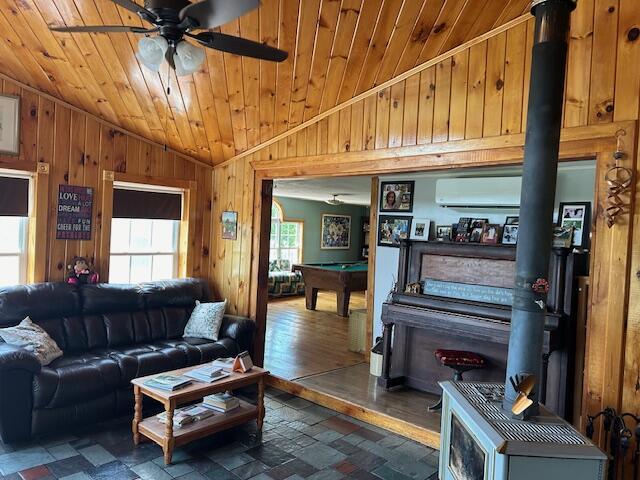 living room with wood walls, a ceiling fan, pool table, wooden ceiling, and lofted ceiling