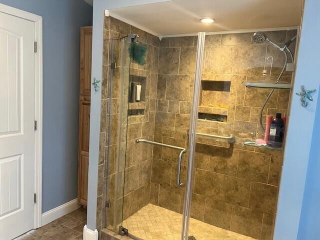 full bath with baseboards and a shower stall