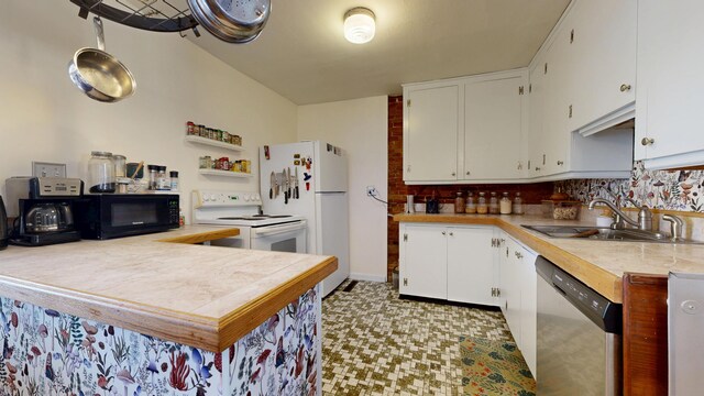 kitchen with a sink, white appliances, light countertops, white cabinetry, and tasteful backsplash