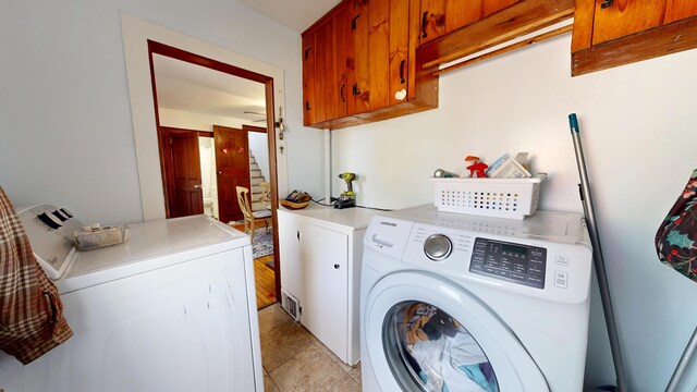 laundry room with independent washer and dryer and cabinet space