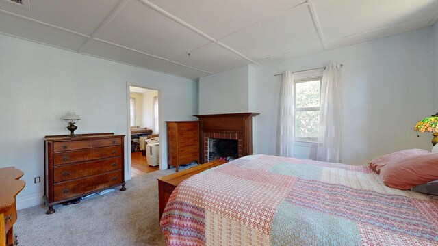 bedroom featuring carpet floors, a brick fireplace, and visible vents