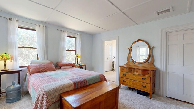 bedroom featuring light colored carpet and visible vents