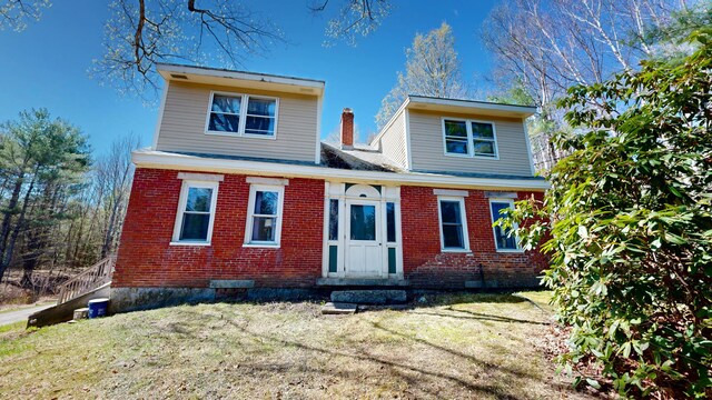view of front of house featuring a front yard and brick siding