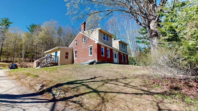 view of property exterior with a chimney