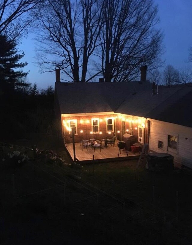 back of house featuring a patio and a chimney