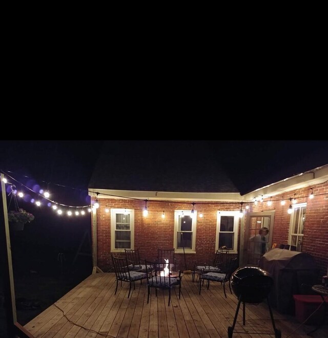 exterior space featuring outdoor dining area and a grill