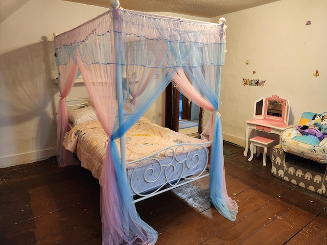 bedroom featuring wood-type flooring and baseboards