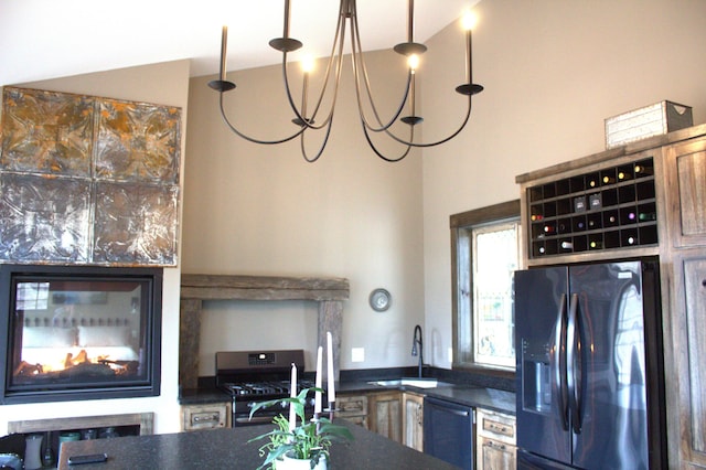 kitchen featuring a sink, appliances with stainless steel finishes, and dark countertops
