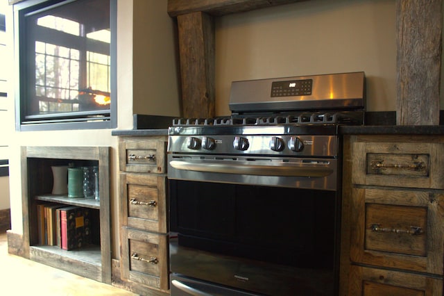 kitchen featuring dark countertops and stainless steel gas range oven