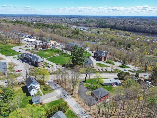 birds eye view of property with a view of trees