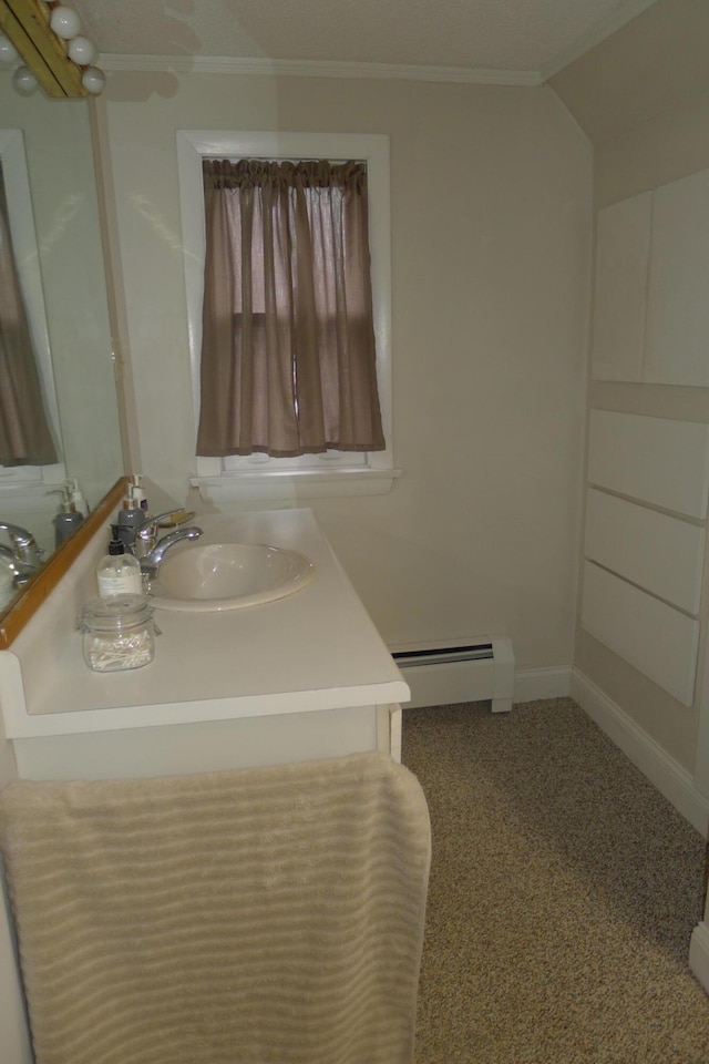 bathroom with crown molding, baseboard heating, and vanity