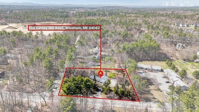 birds eye view of property featuring a forest view and a mountain view