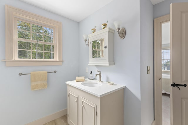 20 Campbell Rd, Southport, ME 04576 - bathroom with vanity, baseboards, and wood finished floors