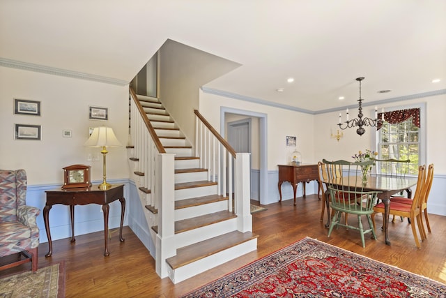 20 Campbell Rd, Southport, ME 04576 - dining space featuring stairway, crown molding, wood finished floors, a chandelier, and wainscoting