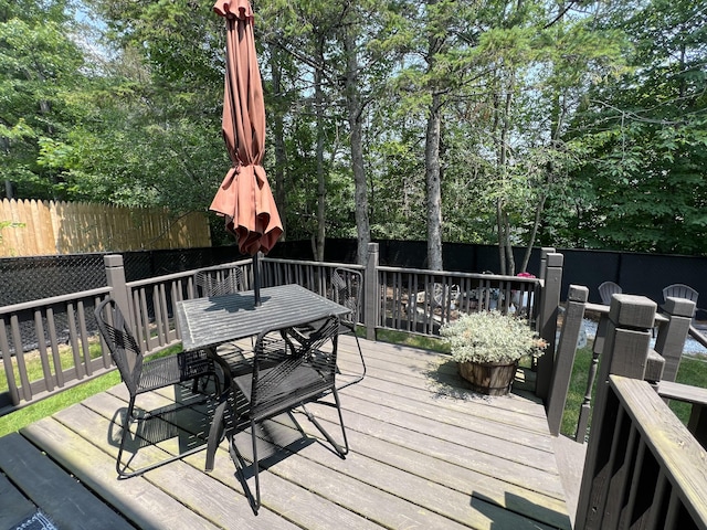 17 Fieldstone Dr, Bangor, ME 04401 - wooden terrace featuring outdoor dining area, a fenced backyard, and view of scattered trees