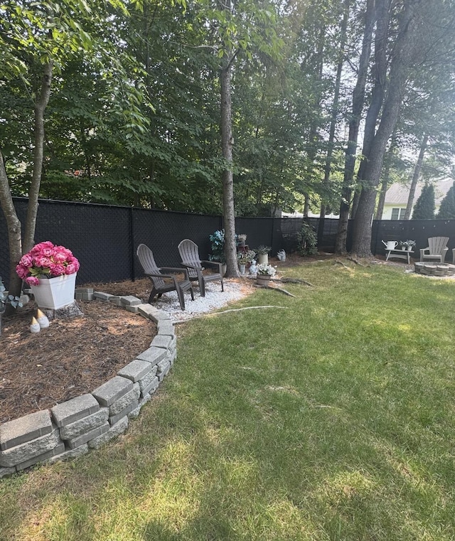 17 Fieldstone Dr, Bangor, ME 04401 - fenced backyard with a fire pit