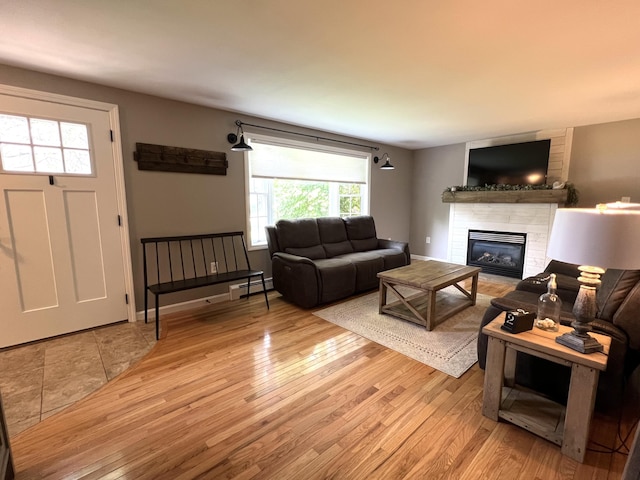17 Fieldstone Dr, Bangor, ME 04401 - living room with wood finished floors, plenty of natural light, and a tiled fireplace