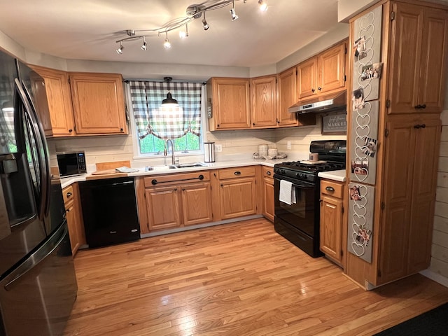 17 Fieldstone Dr, Bangor, ME 04401 - kitchen featuring black appliances, under cabinet range hood, light wood finished floors, and light countertops