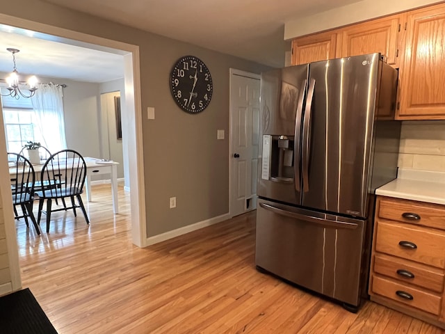 17 Fieldstone Dr, Bangor, ME 04401 - kitchen with stainless steel fridge with ice dispenser, a chandelier, light wood-style flooring, and light countertops