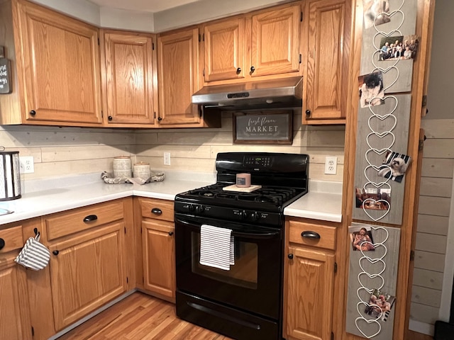 17 Fieldstone Dr, Bangor, ME 04401 - kitchen with black range with gas cooktop, under cabinet range hood, light countertops, and light wood-style floors