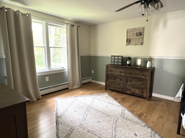 17 Fieldstone Dr, Bangor, ME 04401 - bedroom with wood-type flooring, a baseboard radiator, and a ceiling fan