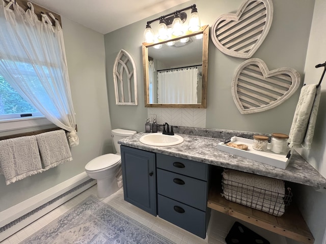 17 Fieldstone Dr, Bangor, ME 04401 - full bath featuring baseboard heating, vanity, and decorative backsplash
