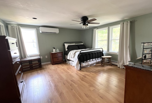 17 Fieldstone Dr, Bangor, ME 04401 - bedroom with a wall mounted air conditioner, light wood-type flooring, and ceiling fan