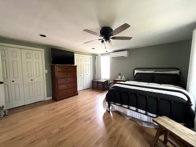 17 Fieldstone Dr, Bangor, ME 04401 - bedroom with two closets, a wall mounted air conditioner, light wood-type flooring, and a ceiling fan